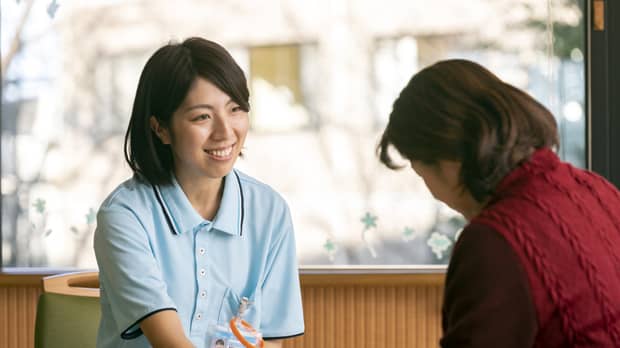 高齢者の女性と支援相談員の写真